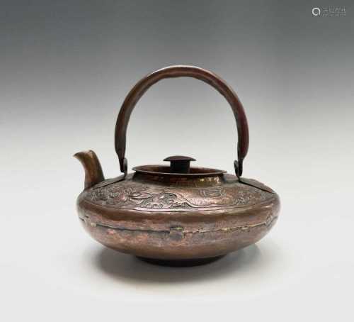 A Chinese copper teapot, 19th century, decorated with stylis...
