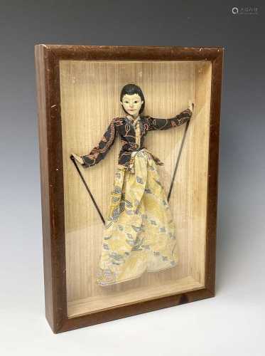 An Indonesian doll, in a mahogany glazed display case, 50.5 ...