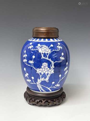 A large Chinese prunus pattern ginger jar, with wood stand a...