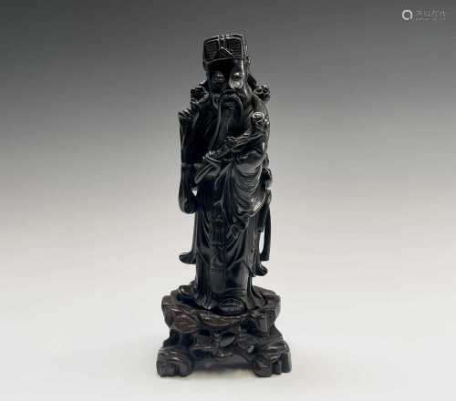 A Chinese hardwood figure of an immortal, late 19th century,...
