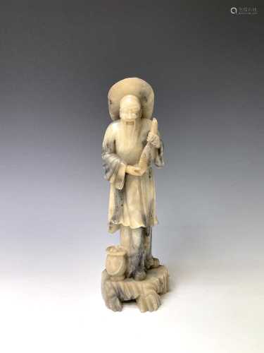 A Chinese white soapstone figure, 20th century, carved as a ...
