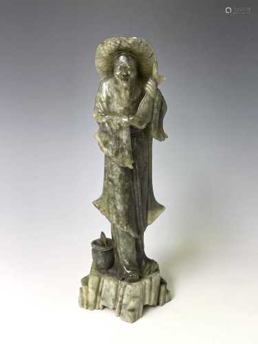 A Chinese green soapstone figure, 20th century, carved as a ...