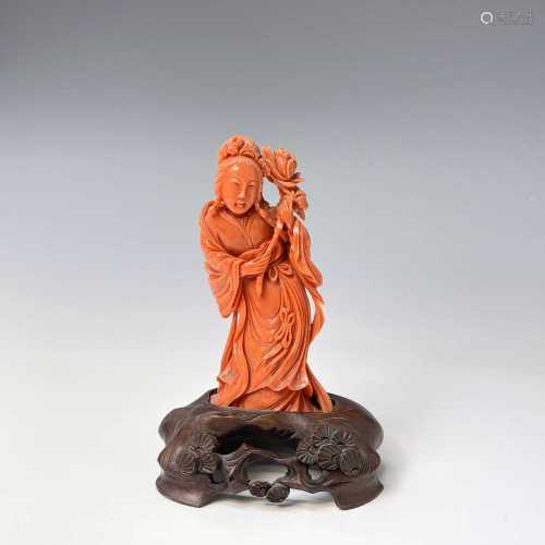 A Chinese carved coral figure of Guanyin holding a lotus, 19...