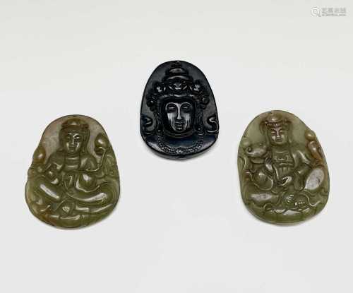 A Chinese jade amulet, 20th century, carved with a seated fi...