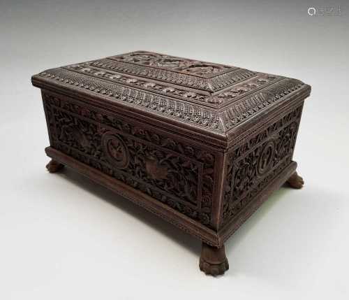 An Indian carved sandalwood box, 19th century, the cover car...