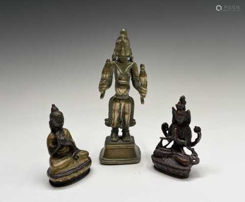 A small bronze figure of a seated Buddha, heightened with gi...