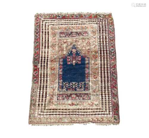 A Ghiordes Prayer rug, West Anatolia, circa 1800, the indigo...