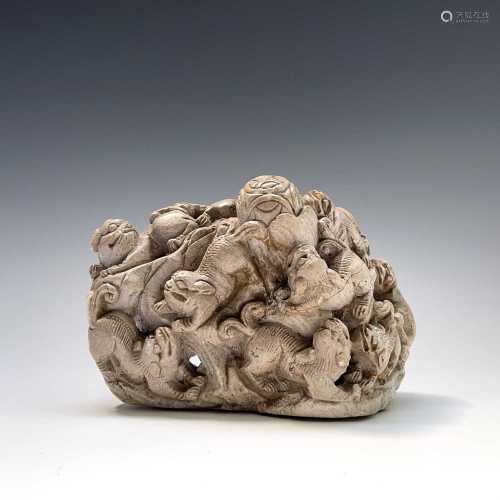 A Chinese carved white stone group, circa 1900, depicting ni...