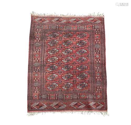 A Pakistan rug, the madder field with seven rows of three me...