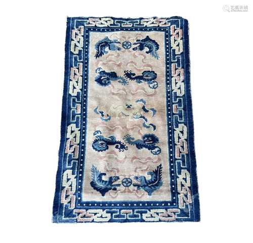 A Chinese rug, the peach field with rows of dogs of fo chasi...