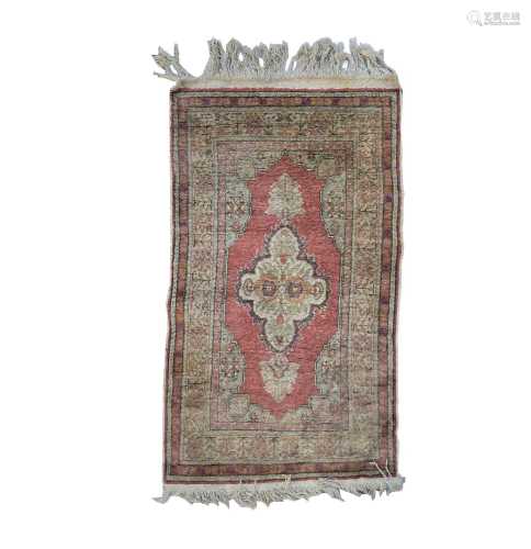 A Turkish art silk rug, circa 1930-1950, the madder field wi...