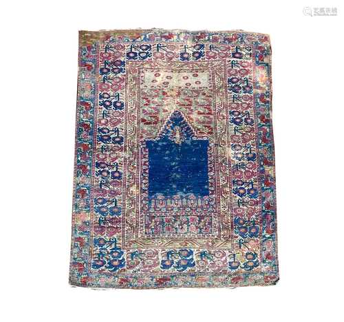 A Ghiordes Prayer rug, West Anatolia, the indigo mihrab, fol...