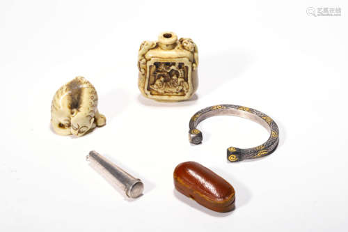 A Set Of Carved Amber And Bone Ornaments