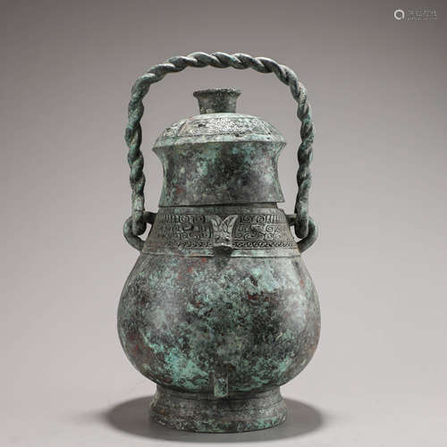 A Chinese Bronze Taotie Mask Drinking Vessel