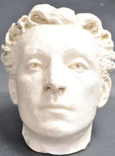 20TH CENTURY NATURALISTIC GLAZED PLASTER BUST OF A YOUNG MAN...