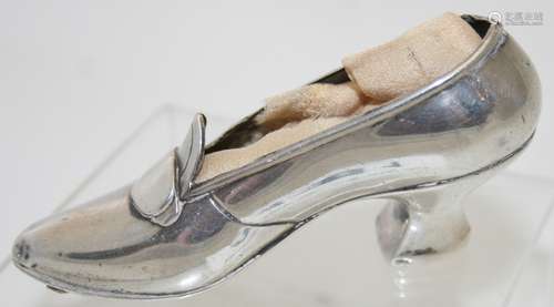 A ladies shoe pin cushion, marked sterling, lacking the cush...