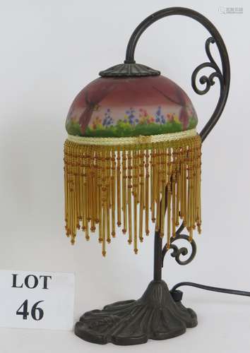 An Art Nouveau style table lamp with glass shade hand decora...