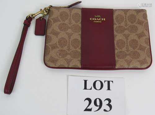 A Coach Monogram leather wrist bag pouch with Burgundy leath...