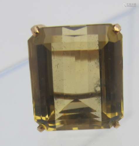 An emerald cut citrine set in yellow metal, indistinct mark ...