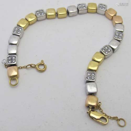 An unusual two colour gold and diamond bracelet with safety ...