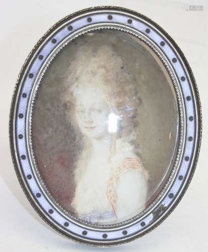 An oval enamelled frame inset with painting of a Georgian la...