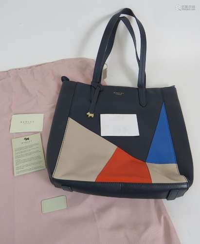 A Radley tote bag in navy blue leather with abstract red, be...