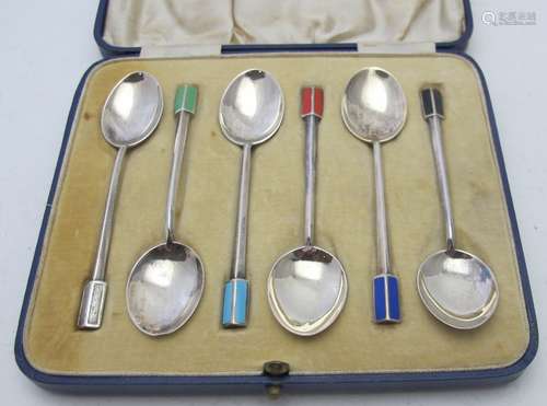 A set of six silver and enamelled coffee spoons, each termin...