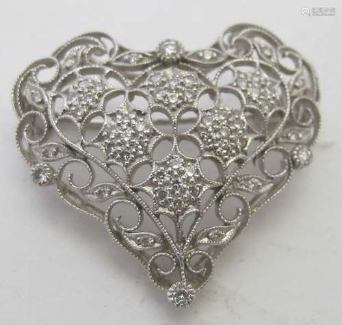 An 18ct white gold brooch in the shape of a heart with openw...