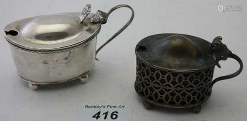 A silver mustard pot with pierced decoration,