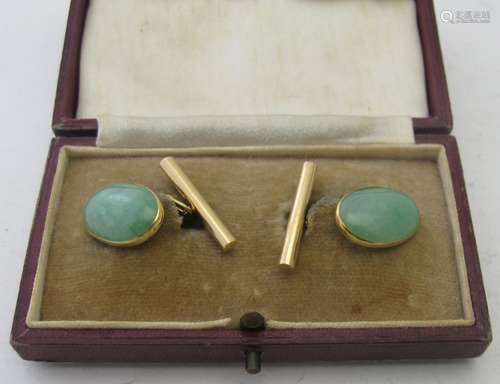 A pair of yellow metal jade cuff links marked 18, boxed. Con...