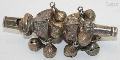 An antique babies rattle/whistle with embossed foliate desig...