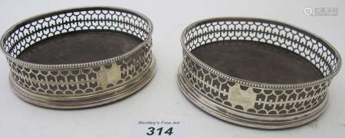 A pair of Georgian silver coasters with pierced decoration, ...