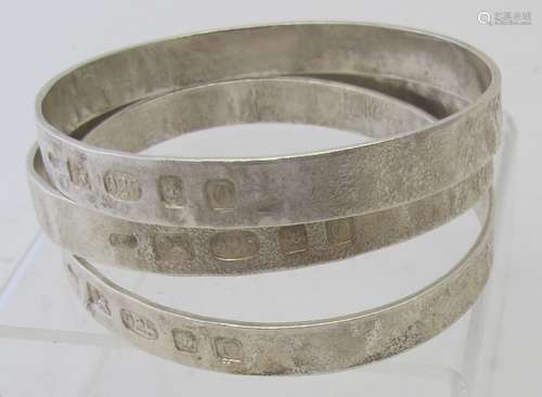 A collection of three heavy silver handmade bangles, London ...