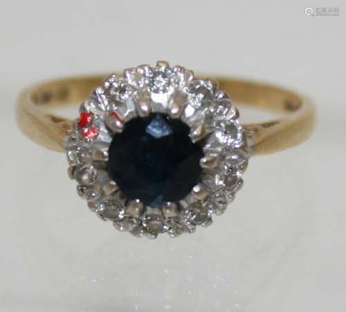 An 18ct yellow gold sapphire and diamond cluster ring.