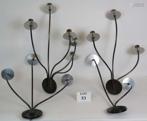 Four stylish steel and brass wall lights with varying sconce...