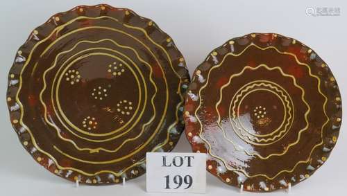 Two contemporary slipware chargers both with concentric line...