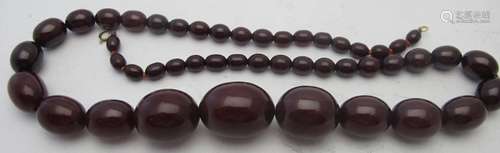 A graduated cherry amber necklace, approx 25