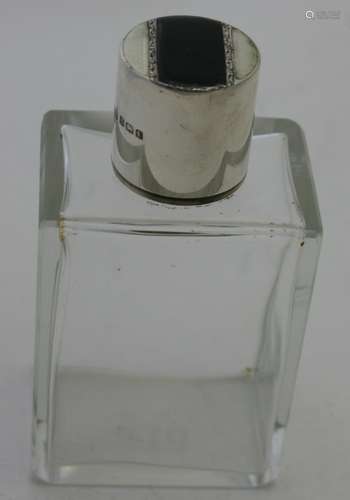 A rectangular glass scent bottle with black & white enamelli...