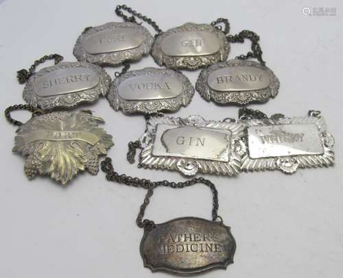 A collection of nine plated decanter labels to include a set...