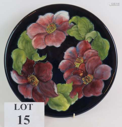 A Moorcroft pottery charger decorated with clematis pattern ...