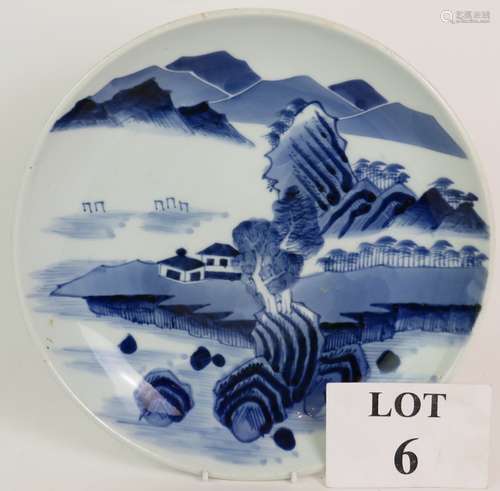 An antique Chinese porcelain dish with blue and white landsc...