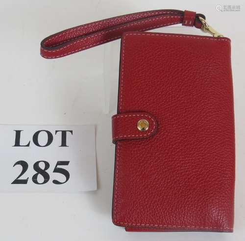 A Coach red grained leather smart phone purse with gold colo...