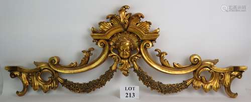 A large composite Rococo style decorative gilt pelmet wall d...