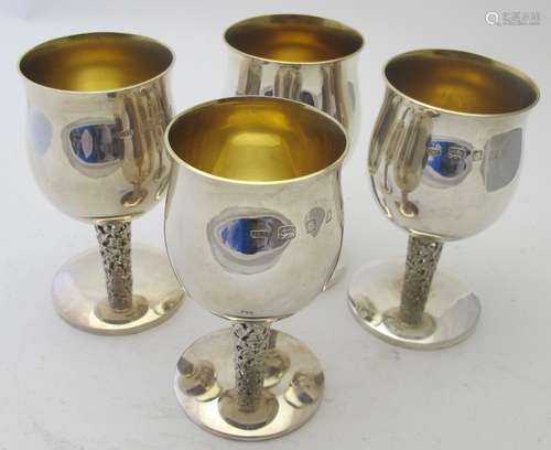 A set of four silver goblets with open work stems & gilded i...