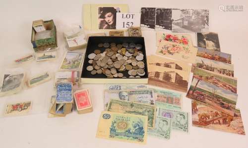 A selection of world coins banknotes, cigarette and collecto...