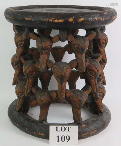 An ethnic African carved wood table or stool made from one p...