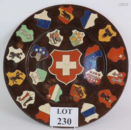 A large glazed pottery late 19th Century armorial charger de...