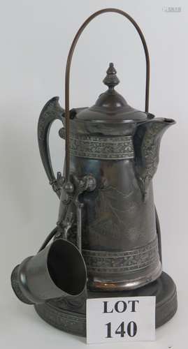 An unusual ornate Britannia metal serving jug and cup with o...