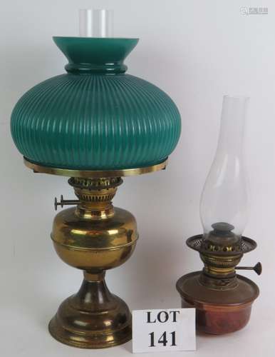 A brass based double wick oil lamp with fluted green shade a...