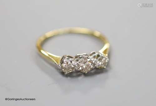 An 18ct and three stone diamond ring, size LM, gross 2.1 gra...